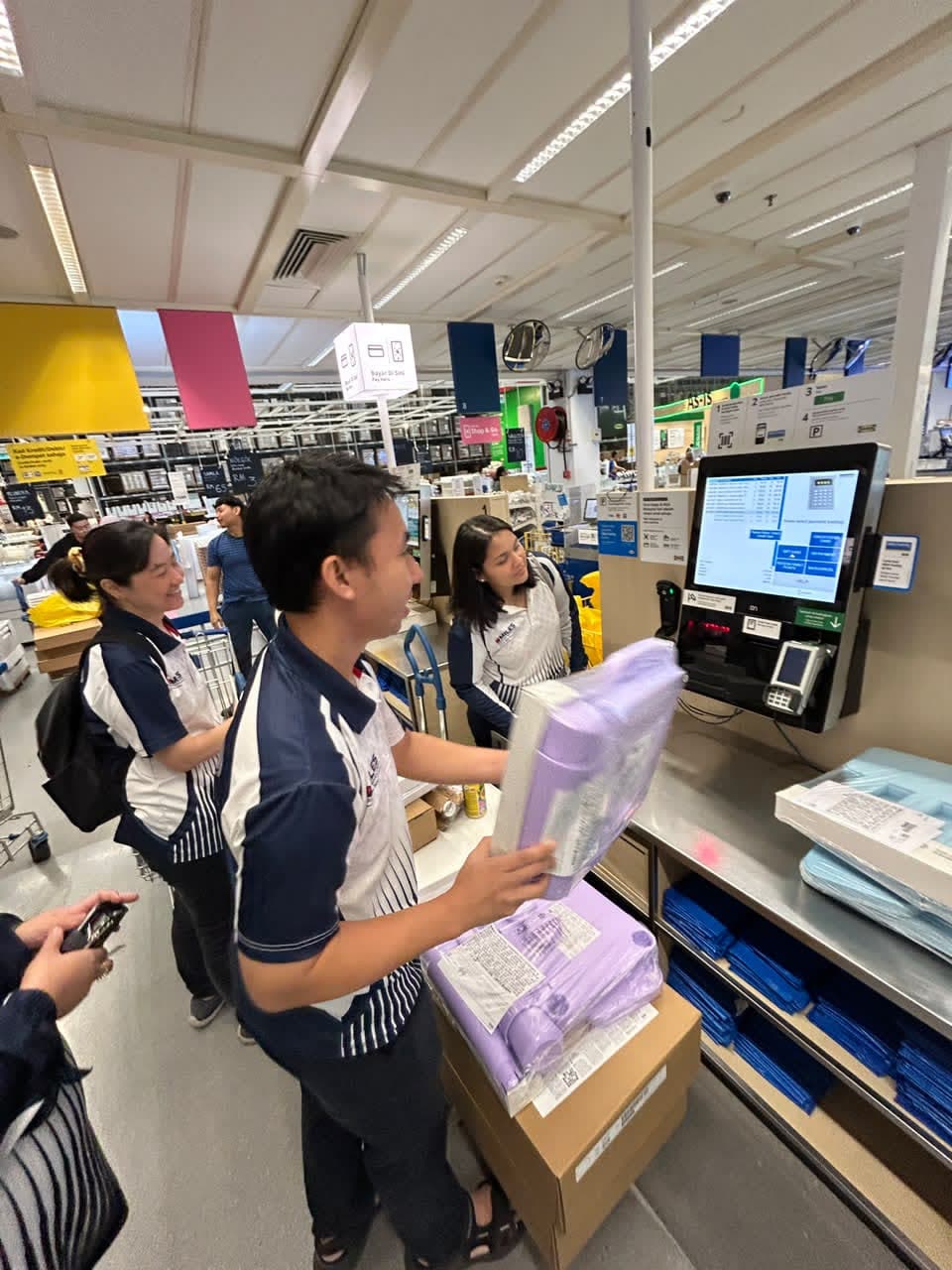 Scanning boxed children's furniture at an IKEA self-checkout