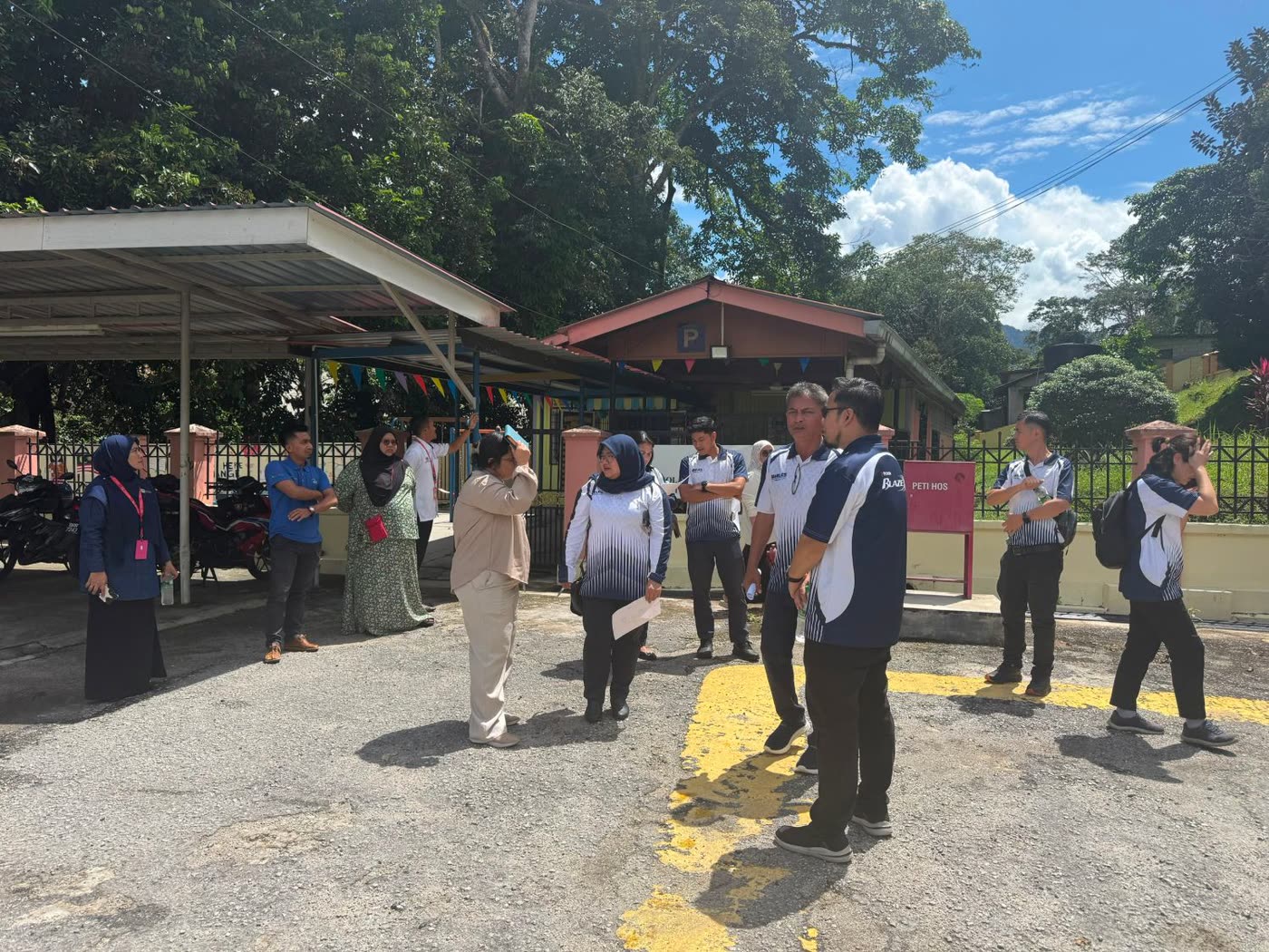 Team in Petron shirts walking the hospital grounds on a site visit