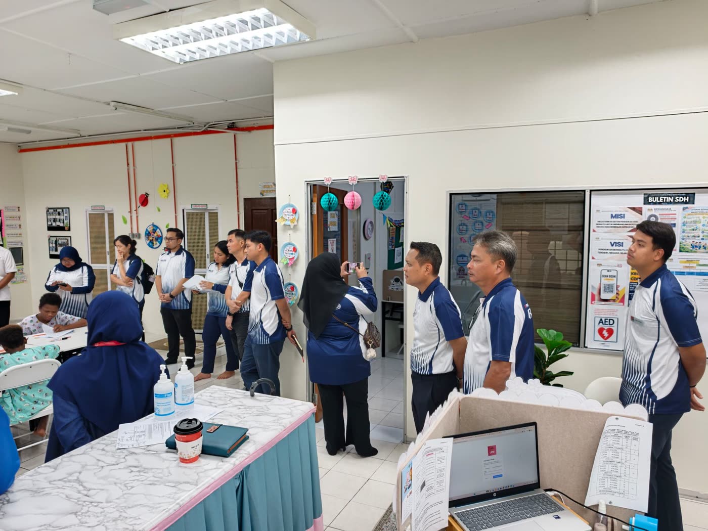 Team visiting the Sekolah Dalam Hospital classroom while children study